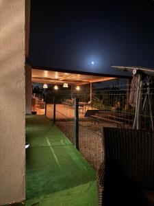 a tennis court at night with the lights on at Casa Oliveira in Silves