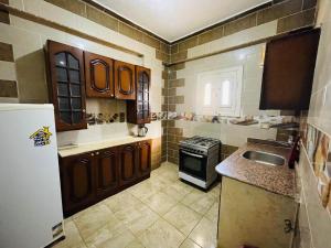a kitchen with a sink and a refrigerator at Dar Alsalam Suites in Siwa