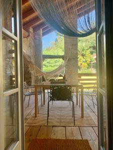 a dining room with a table and a hammock at A casa di Sophi Lago Maggiore Private outdoor Sauna in Angera