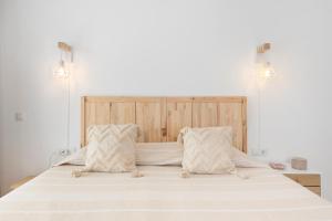 a large white bed with two pillows on it at The loving hummingbird in Mijas Costa +24 photos