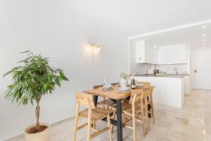 a kitchen and dining room with a wooden table and a potted plant at The loving hummingbird in Mijas Costa