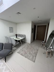 a living room with a table and chairs at Hotel apartment in Sharjah