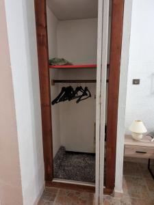 a room with a closet with hangers in it at Chambre avec salle de bain in Penta-di-Casinca