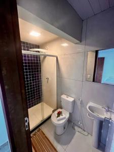 a bathroom with a toilet and a shower and a sink at Casa Brisa Noronha in Fernando de Noronha +22 photos