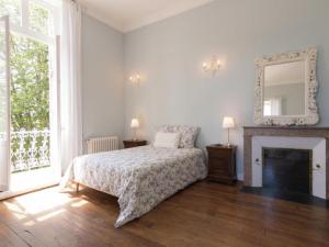 a bedroom with a bed and a fireplace and a mirror at Le Petit Chateau in Brouchaud +23 photos