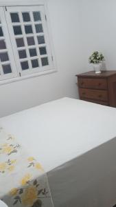 a white room with a window and a bed at Pensão da tia Léia in Belém