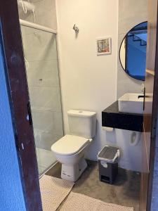 a bathroom with a toilet and a sink at A Casa Luna in Porto Seguro