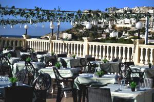 a restaurant with tables and chairs with a view of the city at Hotel Incontro in Peschici