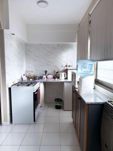 a kitchen with a stove and a counter top at Departamento temporal Mariano in Santa Rosa