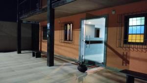 a room with a large glass door in a building at Pousada Paraiso - Predio N 124 in Guarapari