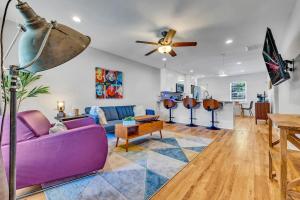 a living room with a purple couch and a table at Stylish Duplex Near East Lake Golf Course-Unit B in Decatur