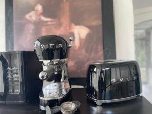 a coffee maker sitting next to a microwave at Bedroom with extension on Veranda in Yvoir