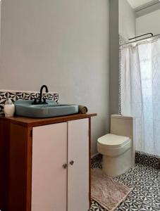 a bathroom with a sink and a toilet at Mar de Lava in Mexico City +27 photos