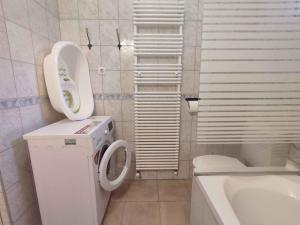 a white bathroom with a toilet and a sink at Holiday home in Balatonboglar 38776 in Balatonboglár +42 photos