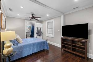 a bedroom with a bed and a flat screen tv at Historic Home in Downtown Clinton in Clinton