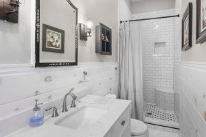 a white bathroom with a sink and a shower at Historic Home in Downtown Clinton in Clinton +44 photos