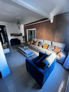 a living room with a couch and a table at Farol da Barra express - suítes in Salvador