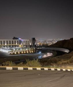 a night view of a building and a road at فيلا فيو السلطان in Abha