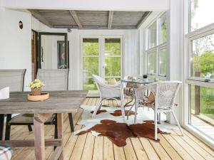 a dining room with a table and chairs at 6 person holiday home in Knebel-By Traum in Knebel +12 photos
