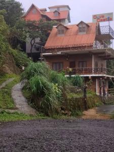 a house with an orange roof on a dirt road at The Royal Summit, Panchalimedu in Suryanelli +15 photos