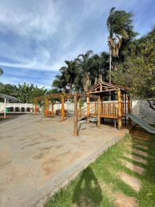 a park with a wooden pavilion and palm trees at APTO EM CONDOMÍNIO FECHADO ( B1-304) in Rio Verde