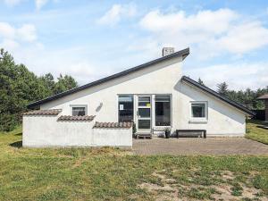 a white house with a bench in front of it at 7 person holiday home in Thisted-By Traum in Thisted