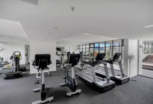 a gym with several exercise bikes and treadmills at Parkview Studio at Harbour Lights in Cairns