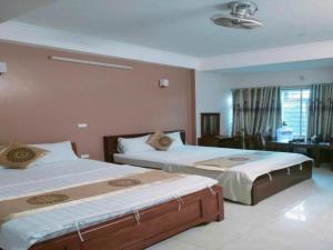a bedroom with two beds in a room at Love Hotel in Hanoi
