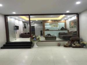 a living room with a large glass window with couches at Love Hotel in Hanoi