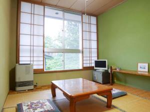 TV a/nebo společenská místnost v ubytování ホテルヴィレッジ圓山 + 4 fotografie