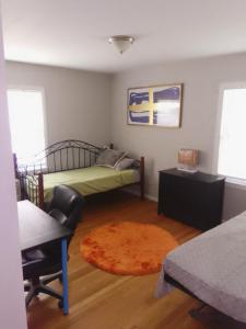 a bedroom with a bed and a rug at Royal Retreat in Kansas City