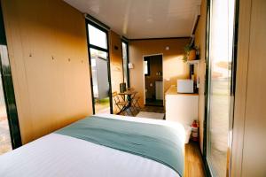 a bedroom with a white bed and a window at Rimu View 3 by Tiny Away in Ruatapu