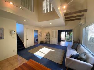a living room with a couch and a rug at The Blue Jem - A central city home away from home! in Napier