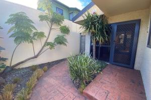 a house with a brick walkway leading to the front door at The Blue Jem - A central city home away from home! in Napier