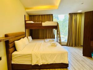 a bedroom with two bunk beds and a ladder at Colors Hotel in Kulai
