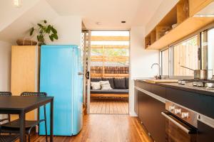 クレセント・ヘッドにある7 Pacific Street Terraces Crescent Headのキッチン(青い冷蔵庫、テーブル付)