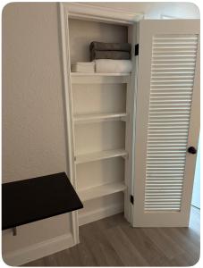 a closet with a door open to a room at Dania Club Luxury Rentals in Dania Beach +2 photos