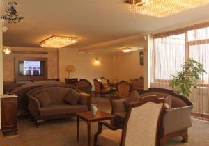 a living room with couches and chairs and a table at Fatih Resadiye Hotel in Istanbul