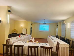 a conference room with tables and chairs and a screen at Fatih Resadiye Hotel in Istanbul