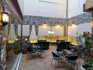 a restaurant with tables and chairs and a brick wall at Fatih Resadiye Hotel in Istanbul