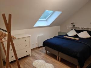 a attic bedroom with a bed and a skylight at Charmant gîte 80m² proche frontière belge, jardin privatif, terrasse, tout inclus, 2 chambres, WiFi - FR-1-510-133 in Sebourg