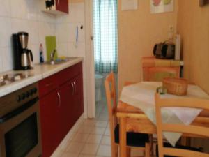 a kitchen with a table and a dining room at Boutique Bungalow in Insel Poel with terrace in Insel Poel