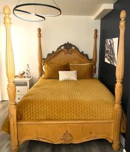 a bedroom with a large wooden bed with yellow sheets at Magical Themed Decor! Pets Welcome! 3 Bedrooms in Chase