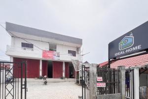 a building with a sign on the side of it at RedDoorz at Ideal Home Banjarmasin in Banjarmasin