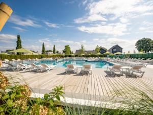 a pool with chaise lounge chairs and a bunch ofitures at Holiday home with gas fireplace & bath in Bemelen