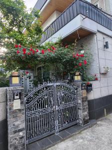 a house with a gate with red roses on it at Lucky House in Busan