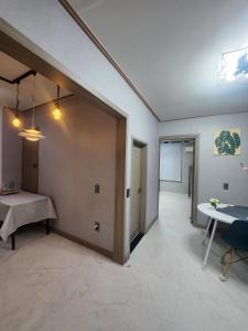 a living room with a door leading to a hallway at Lucky House in Busan
