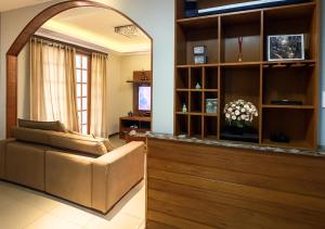 a living room with a couch and a chair at Apartamentos Porto Maravilha in Rio de Janeiro