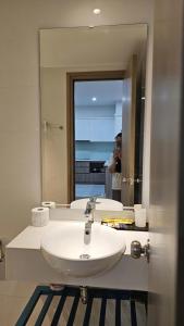 a person taking a picture of a sink in a bathroom at Home stay 2pn Hạ Long in Ha Long +8 photos