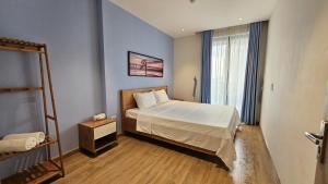 a small bedroom with a bed and a window at Home stay 2pn Hạ Long in Ha Long